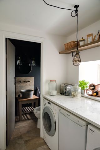 small utility room and dark cloakroom with washing machine