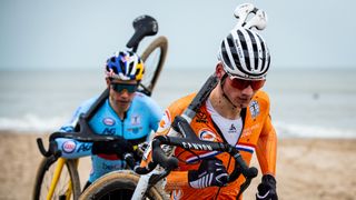 Mathieu van der Poel and Wout van Aert racing on the beach in the 2021 world cyclocross championships