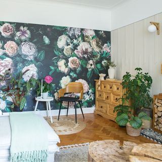 living room with black floral wallpaper and wooden floor