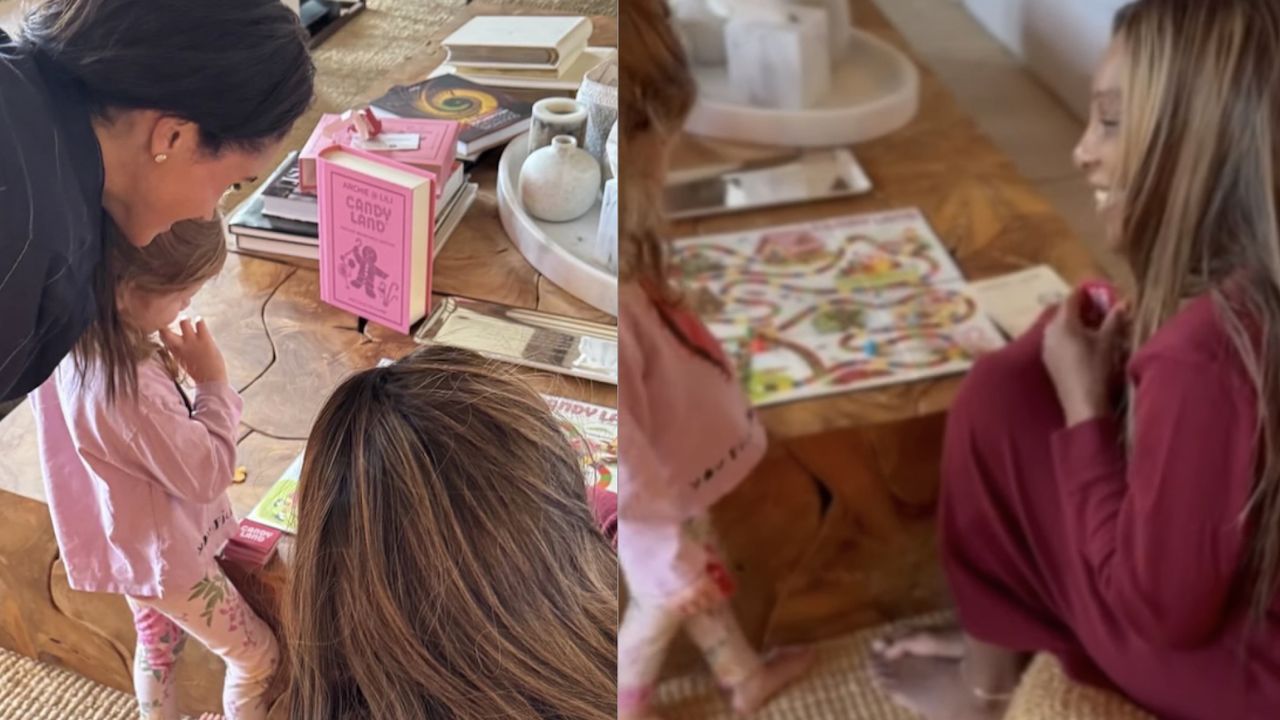 Meghan Markle, Lilibet and Serena Williams sitting on the floor playing Candy Land on a wood coffee table 