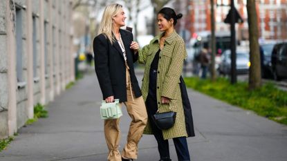 Two women wearing the best fall jackets of 2022.