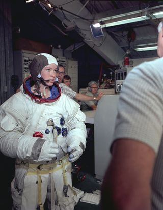 Astronaut Anna Fisher is shown suited up in an Apollo spacesuit as ahead of spacewalk training for an instrument change on the Hubble Space Telescope. This photo was taken on May 8, 1980.
