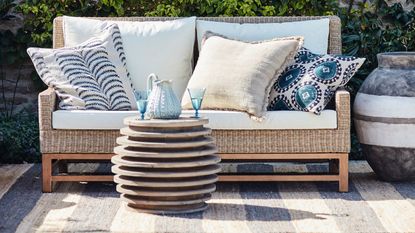 outdoor sofa and rug on a patio