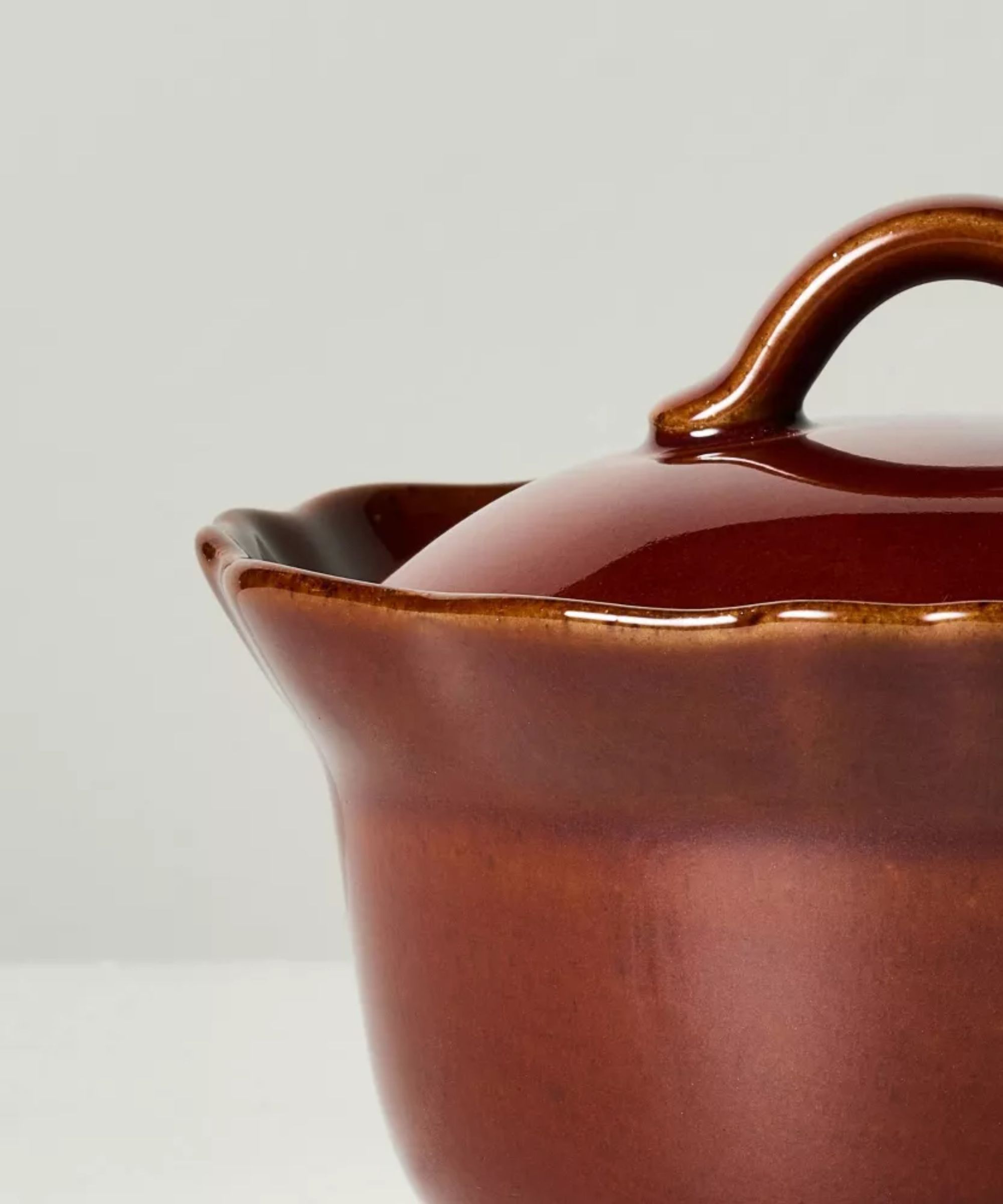 Close up of red scalloped stone ramekin with lid