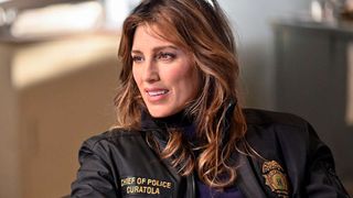 Actress Jennifer Esposito, wearing a official police jacket, as Detective Jackie Curatola in Blue Bloods season 14