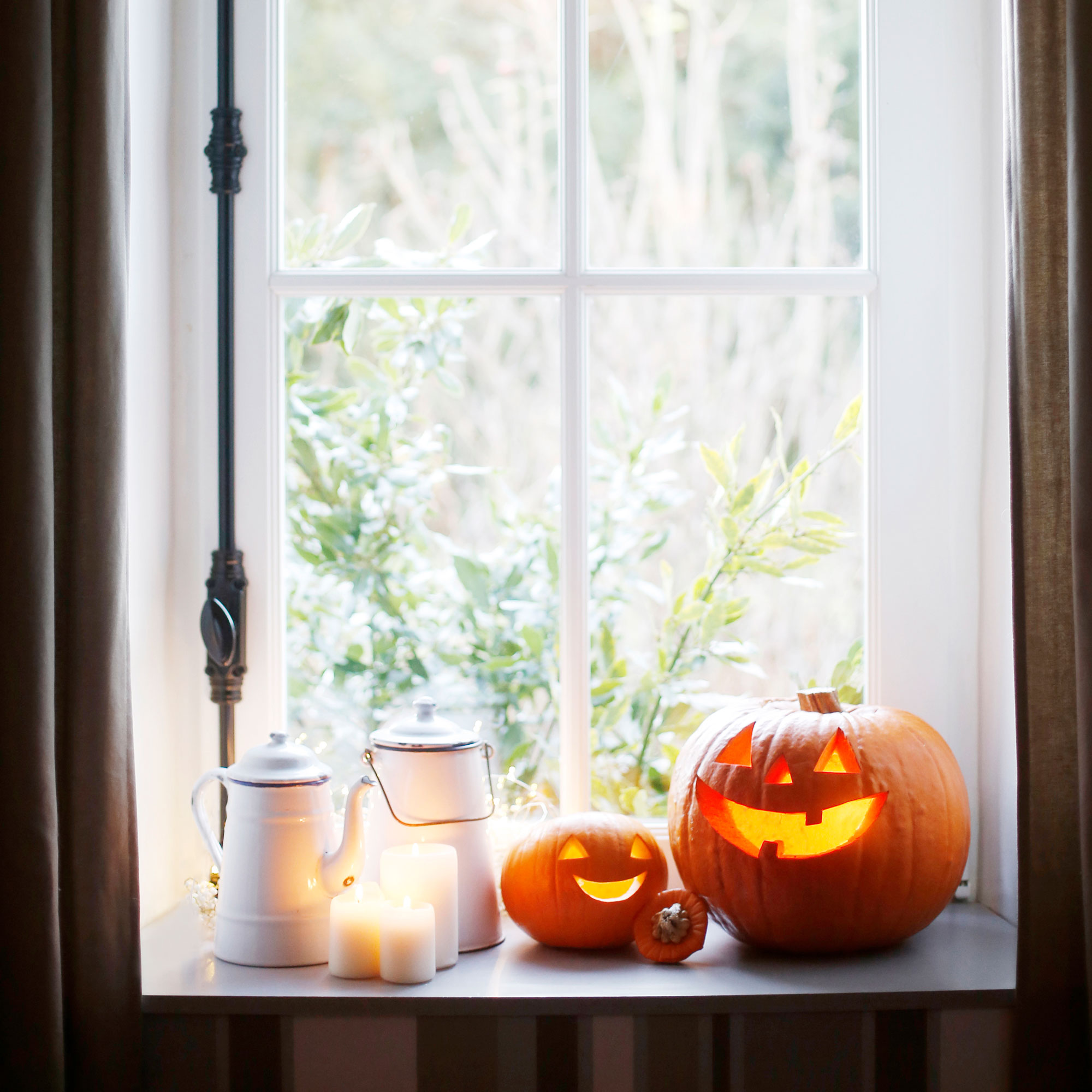 Window with pumpkins with tea lights