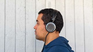 Listing image showing Grado SR325 headphones worn by reviewer