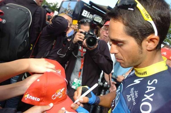 Alberto Contador (Saxo Bank-Tinkoff Bank) signs autographs outside his team bus.