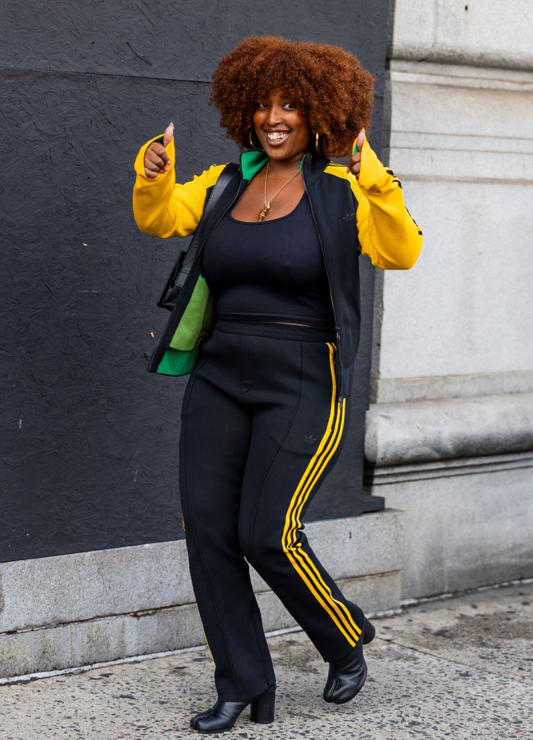 A guest wears yellow track suit jacket, pants outside 3.1 Phillip Lim on September 10, 2023 in New York City.