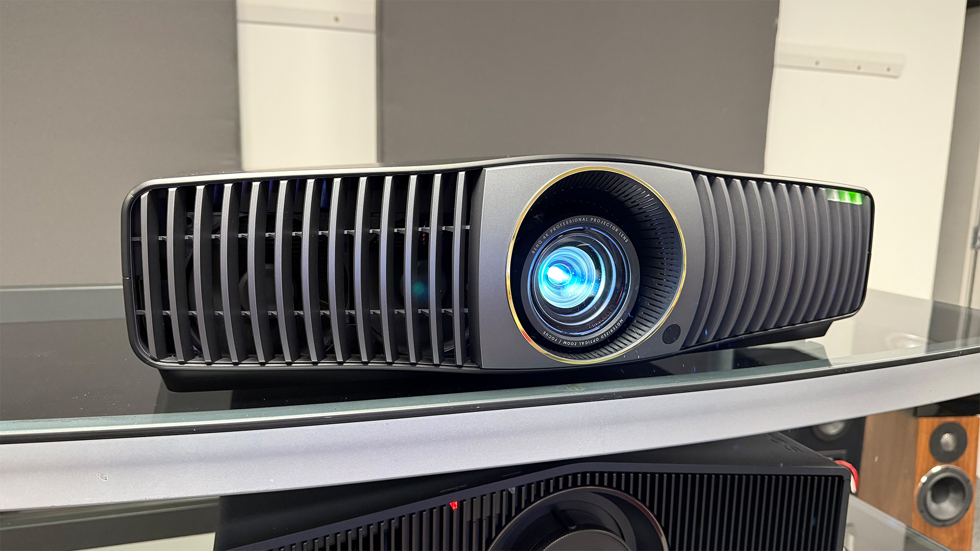 BenQ W5850 home cinema projector with blue light shining from lens