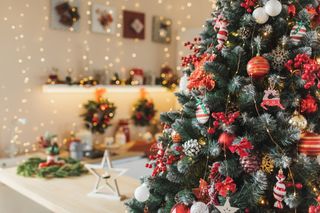 A cosy Christmas kitchen with a close up of a decorated Christmas tree in frame.