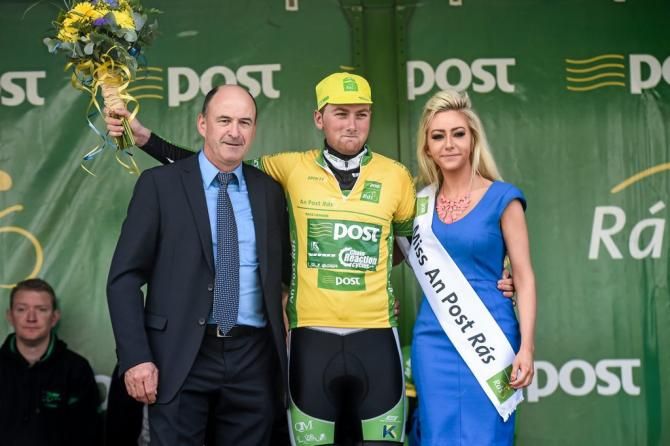 Robert-Jon McCarthy (An Post Chain Reaction) presented with the yellow jersey by Peter Hanley