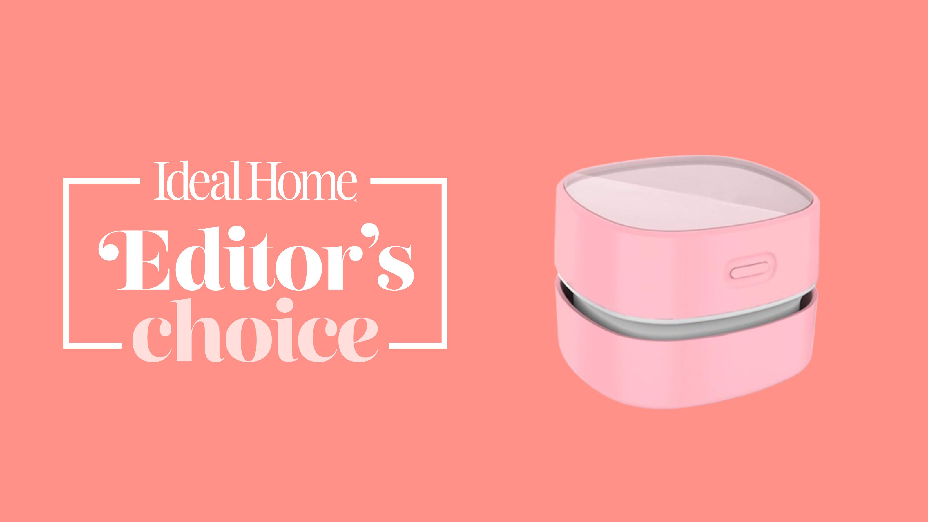 Pink mini desktop vacuum on coral background