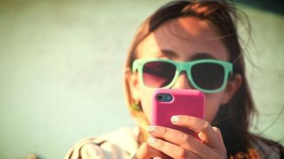 woman staring at phone