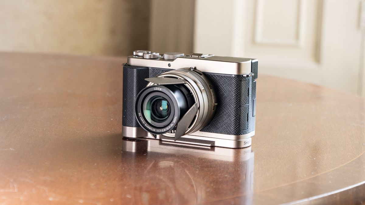 Titanium Gold special edition of the Panasonic Lumix L10 compact camera, on an antique wooden table