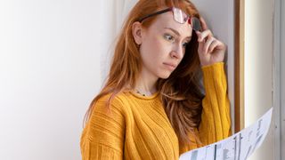 woman looking at high bill