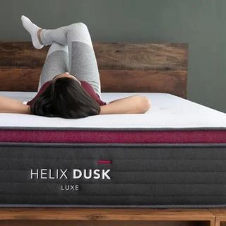 A person lying upside down on Helix Dusk Luxe Mattress.