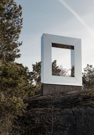 Square shaped sculpture placed in a clearing in a wood