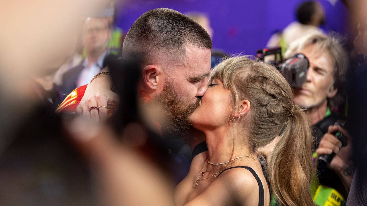 Travis Kelce celebrates and kisses Singer Taylor Swift following Super Bowl 58.