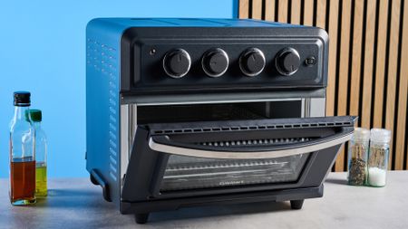 the cuisinart air fryer and toaster oven toa-60 with a black exterior, four temperature and timer dials