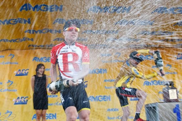 Second-place Leipheimer showers the photographers while winner Horner douses his California bear trophy.