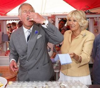 whitstable, united kingdom july 29 embargoed for publication in uk newspapers until 48 hours after create date and time prince charles, prince of wales eats an oyster as camilla, duchess of cornwall looks on during their visit to the whitstable oyster festival on july 29, 2013 in whitstable, england photo by max mumbyindigogetty images