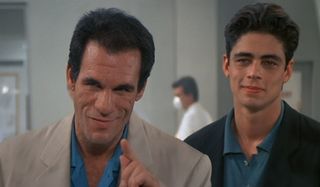 License To Kill Robert Davi and Benicio del Toro smirk together on the factory floor