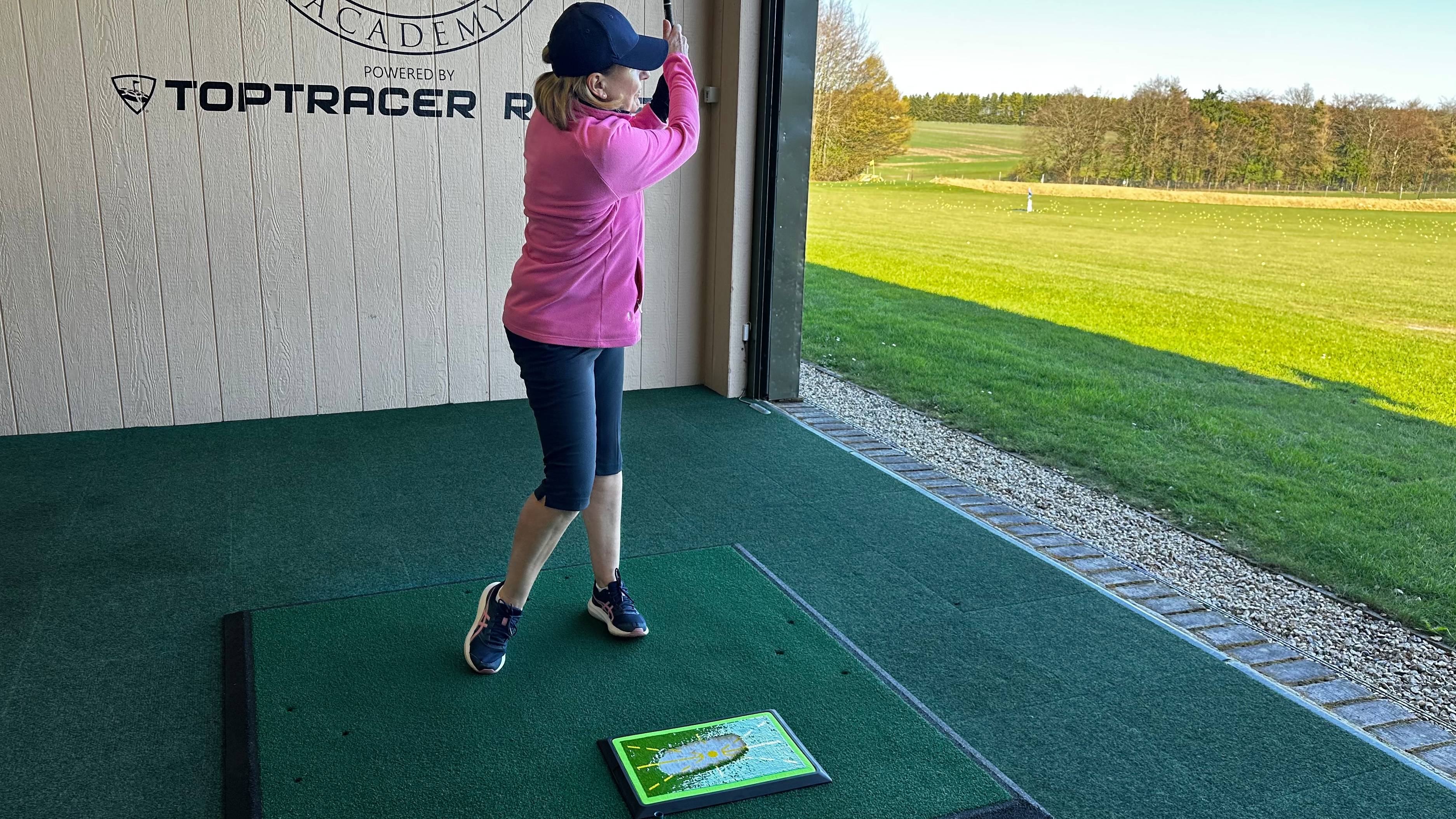 Female golfer using the Golf Trace Strike Pad