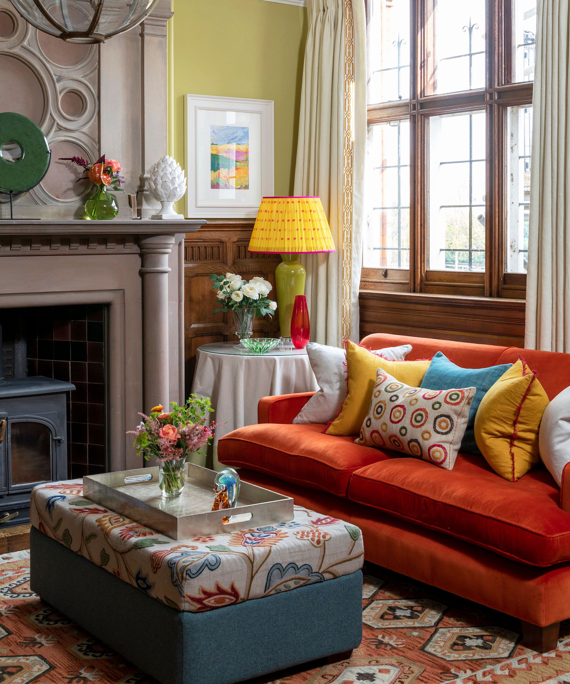 Living room with colorful sofa and bright accents