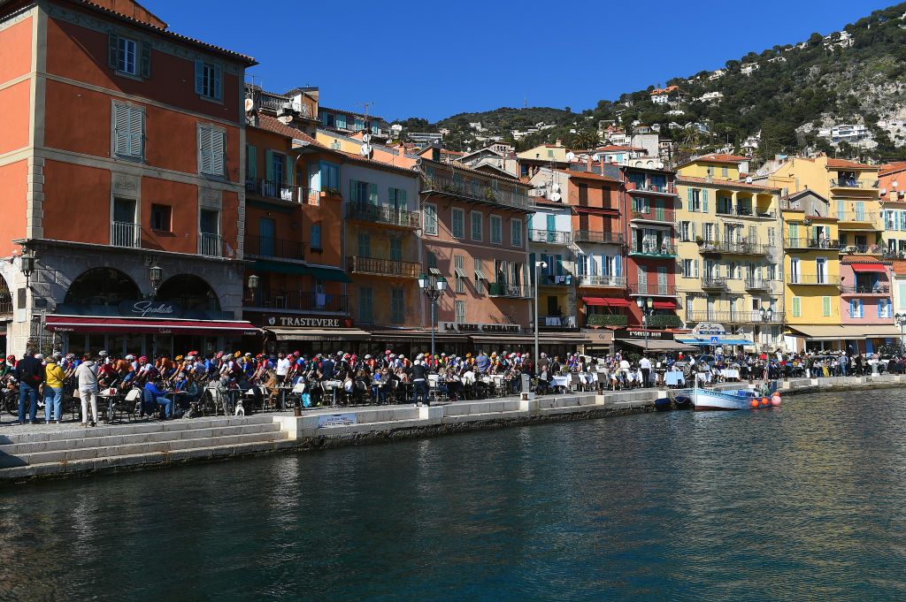 BLAUSASC FRANCE FEBRUARY 20 A general view of the Peloton passing through Villefranche sur Mer start village while fans cheer during the 54th Tour Des Alpes Maritimes Et Du Var Stage 3 a 1126km stage from Villefranche sur Mer to Blausasc on February 20 2022 in Blausasc France Photo by Dario BelingheriGetty Images