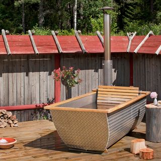 Regal wood-burning hot tub on wooden flooring