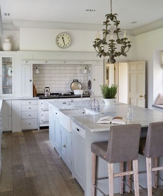 Classic white shaker kitchen with a large island and integrated appliances
