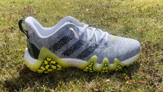 Adidas Codechaos 22 golf shoe resting on the golf course showing off its futuristic design