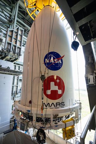 The payload fairing containing NASA's Mars 2020 Perseverance rover is maneuvered into place atop its Atlas V rocket. The image was taken at Cape Canaveral Air Force Station in Florida on July 7, 2020.