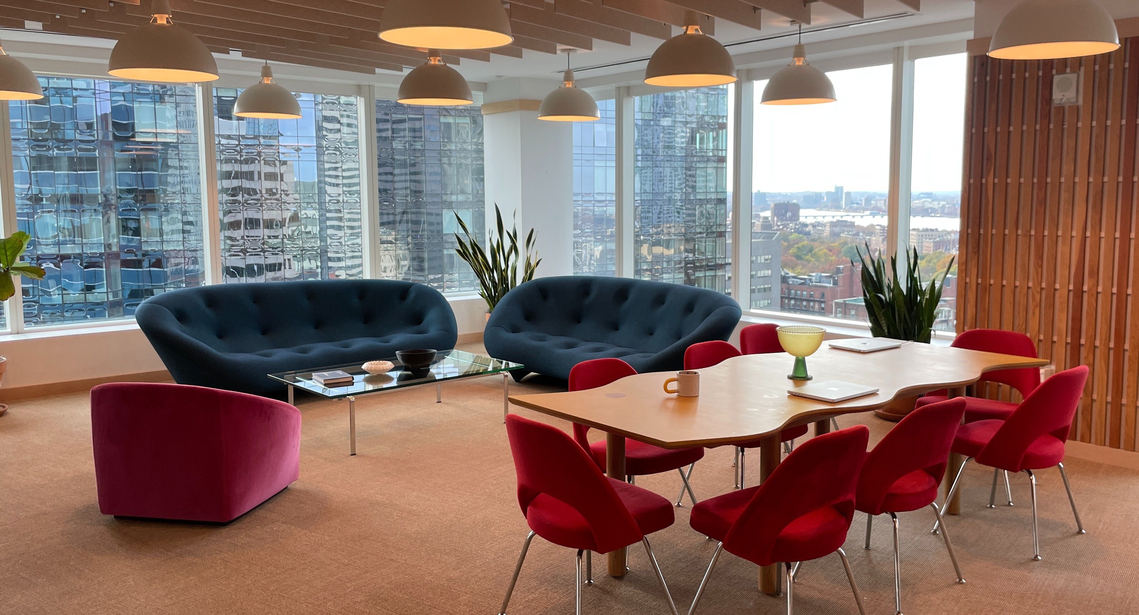 A series of interior shots of an art and objects-filled, dimly lit apartment, a museum's gallery rooms, an empty dance rehearsal room, and colorfully decorated office spaces.