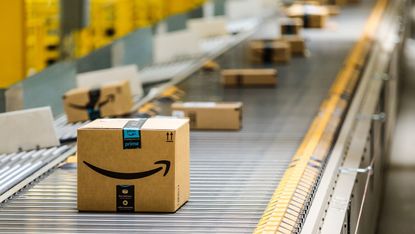 A series of packages from Amazon moving down a conveyor belt