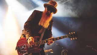 ZZ Top guitarist Billy Gibbons on stage playing an electric guitar
