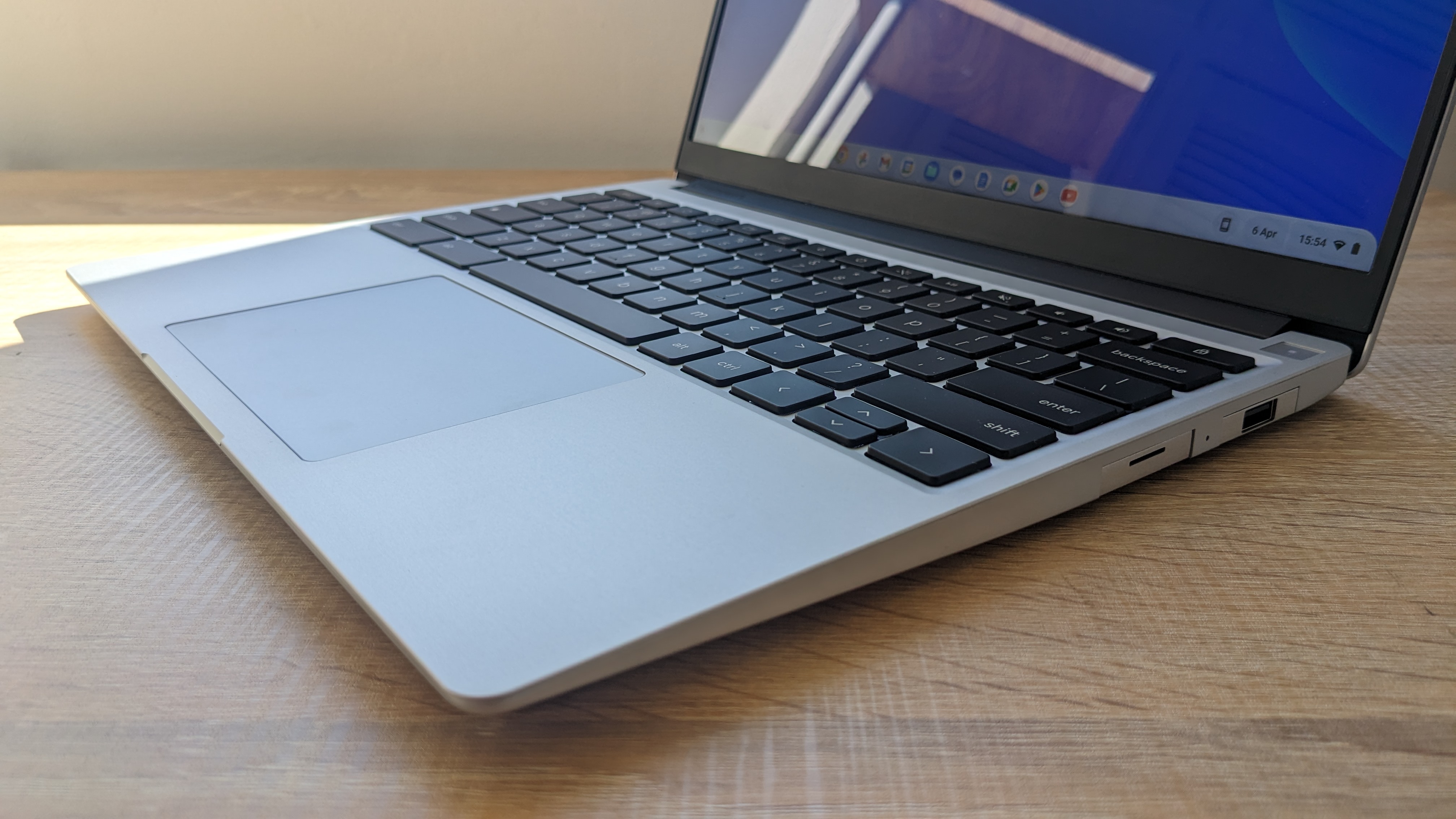 The Framework Laptop Chromebook Edition photographed on a wooden desk.