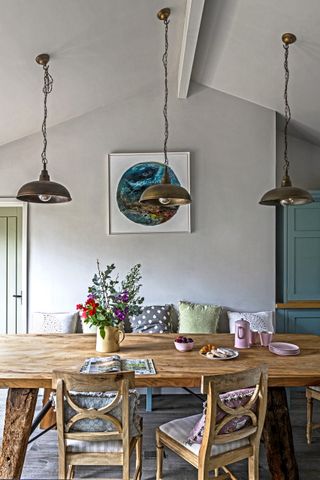 attic kitchen with dining table and flower vase