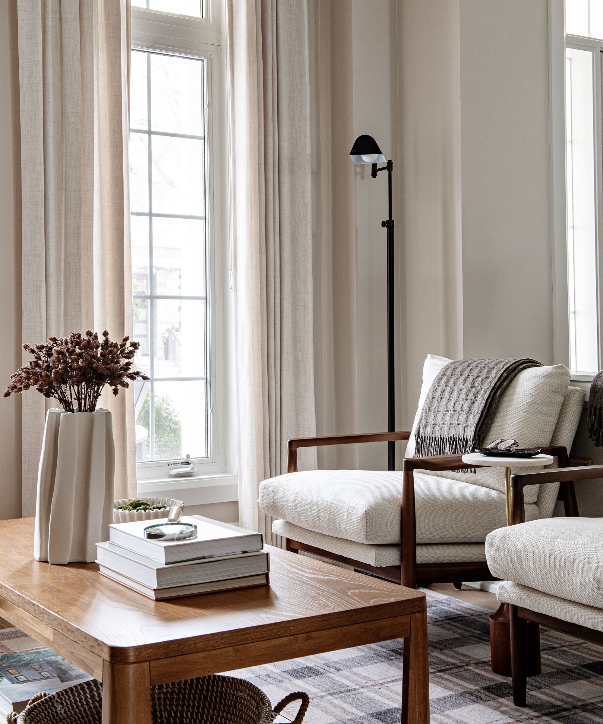 Beige living room with wooden midcentury chairs and a wooden coffee table