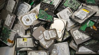 Computer hard disks, electronic scrap, collected inside a bin