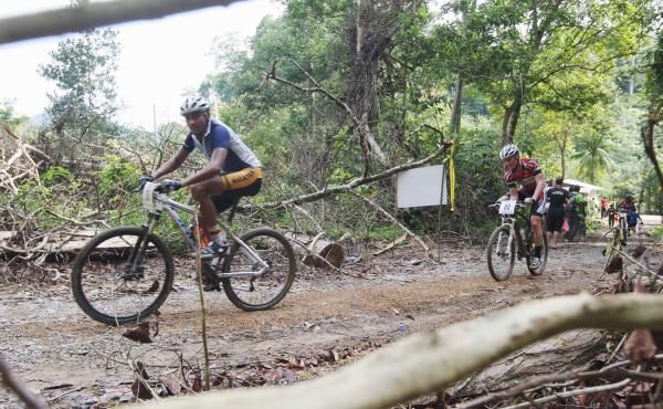 A Malaysian rider rolls past