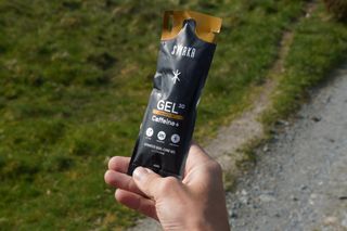 Stefan holding the STYRKR Gel30 energy gel on the Trans Cambrian Way
