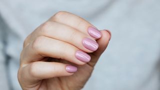 A hand with pink nail polish