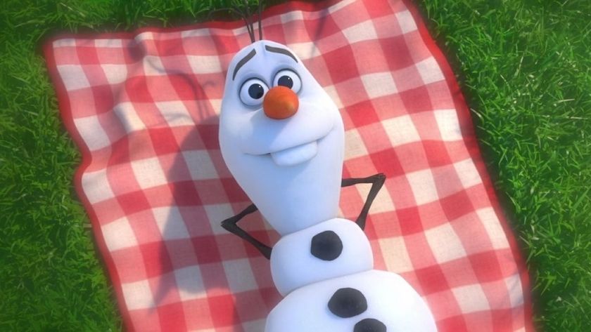 Olaf the snowman staring out into space while laying on a picnic blanket