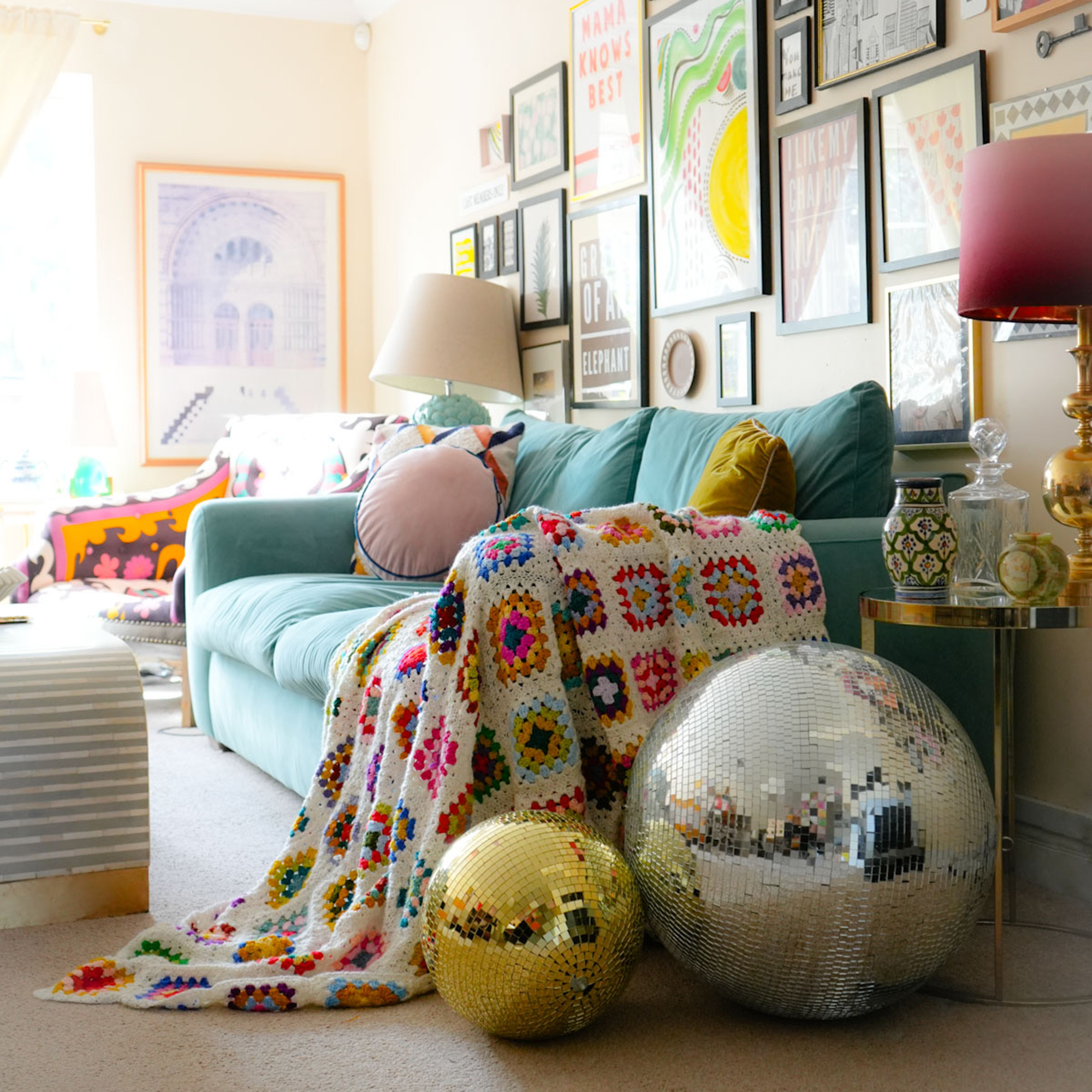 pale blue sofa in a living room with glitter balls by the side of it