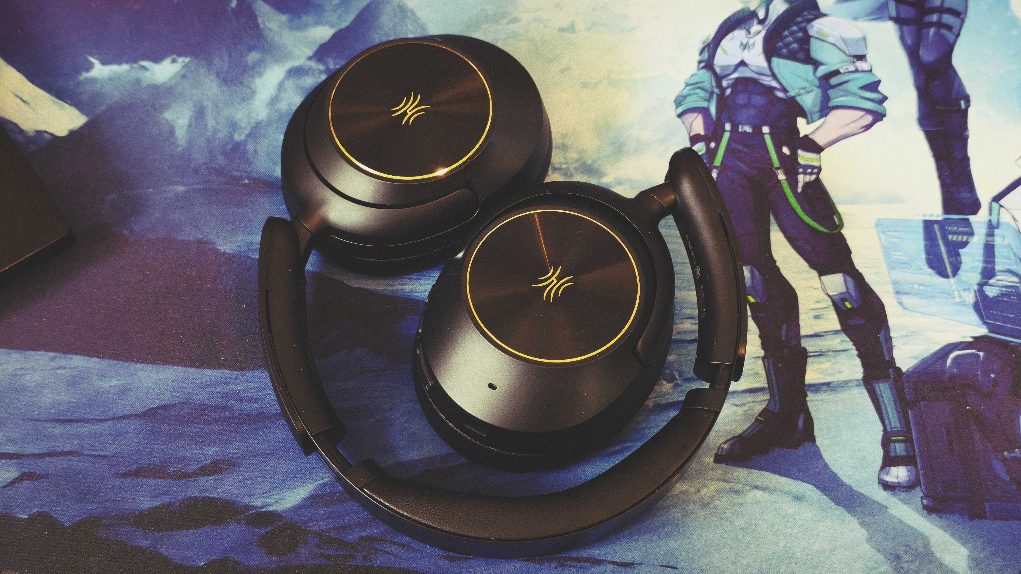 A pair of black OneOdio Focus A6 headphones on a gaming desk mat