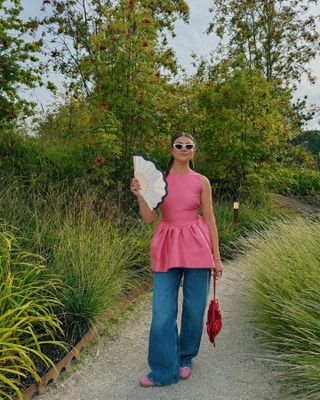 Maren Schia in a pink peplum top and jeans.