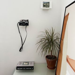 Rust abstract canvas art leaning on desk in bedroom