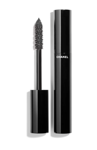 a tube of black chanel mascara in front of a plain backdrop